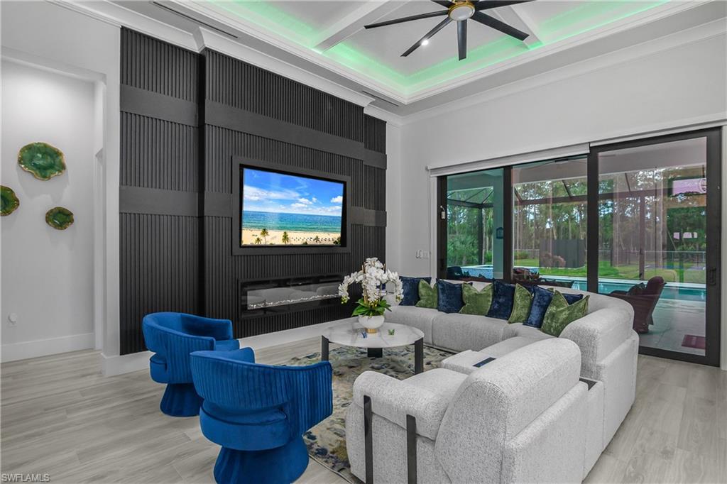 1347 23rd Street Southwest Naples, FL 34117 - Photo 21 of 50 a living room with furniture and a flat screen tv