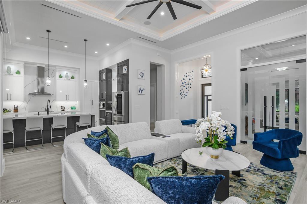1347 23rd Street Southwest Naples, FL 34117 - Photo 22 of 50 a living room with furniture and a dining table