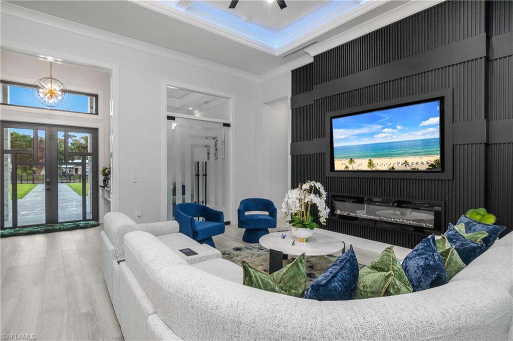 1347 23rd Street Southwest Naples, FL 34117 - Photo 23 of 50 a living room with furniture and a flat screen tv