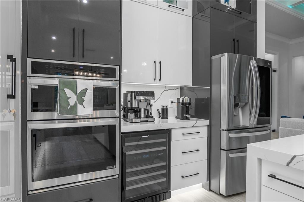 1347 23rd Street Southwest Naples, FL 34117 - Photo 29 of 50 a kitchen with appliances cabinets and a counter top space