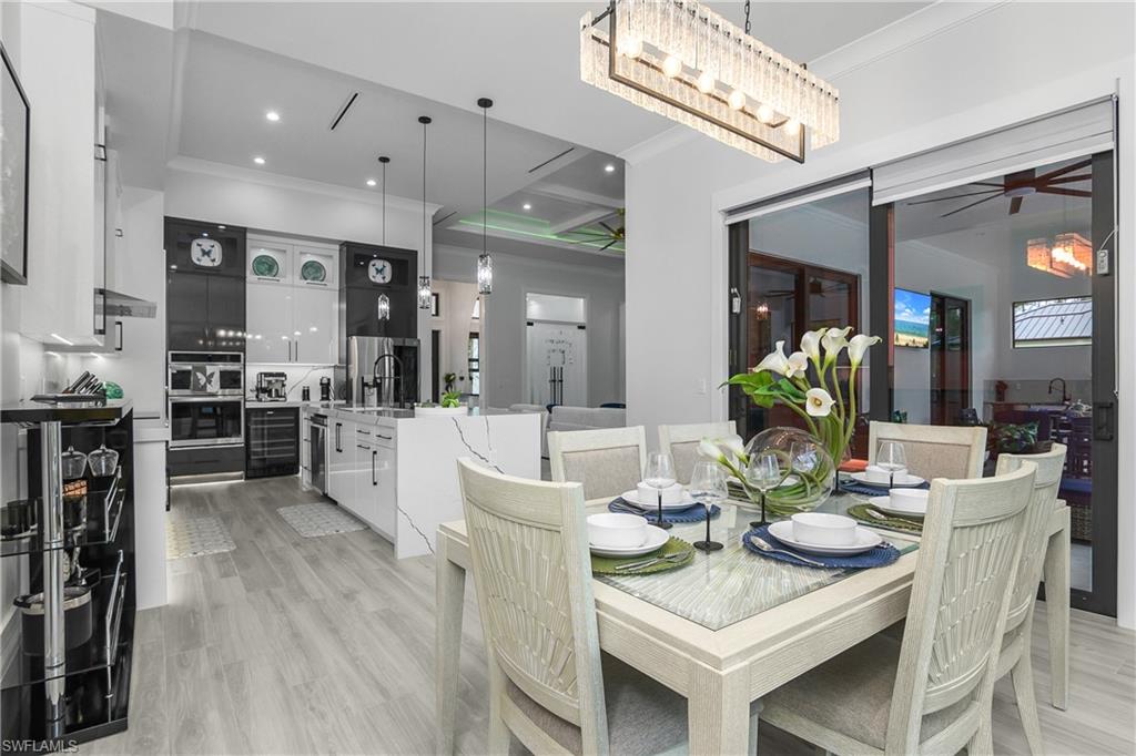 1347 23rd Street Southwest Naples, FL 34117 - Photo 31 of 50 a view of a dining room with furniture and a chandelier