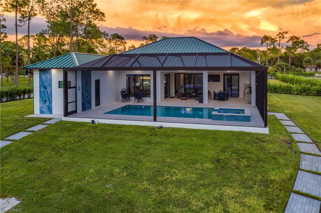 1347 23rd Street Southwest Naples, FL 34117 - Photo 4 of 50 a front view of a house with a yard