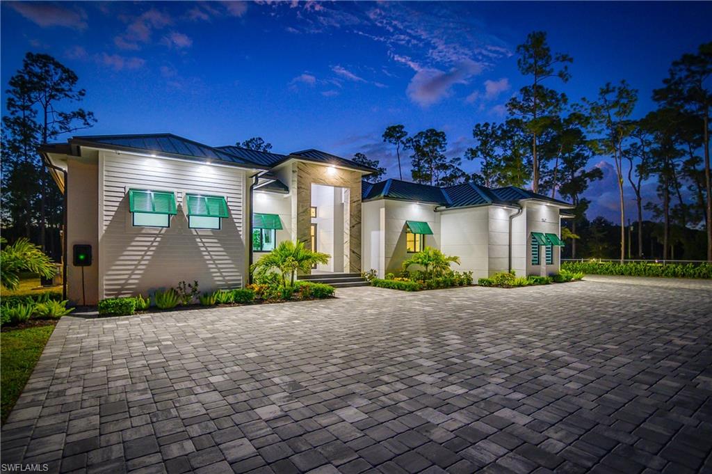 1347 23rd Street Southwest Naples, FL 34117 - Photo 47 of 50 a front view of a house with garden