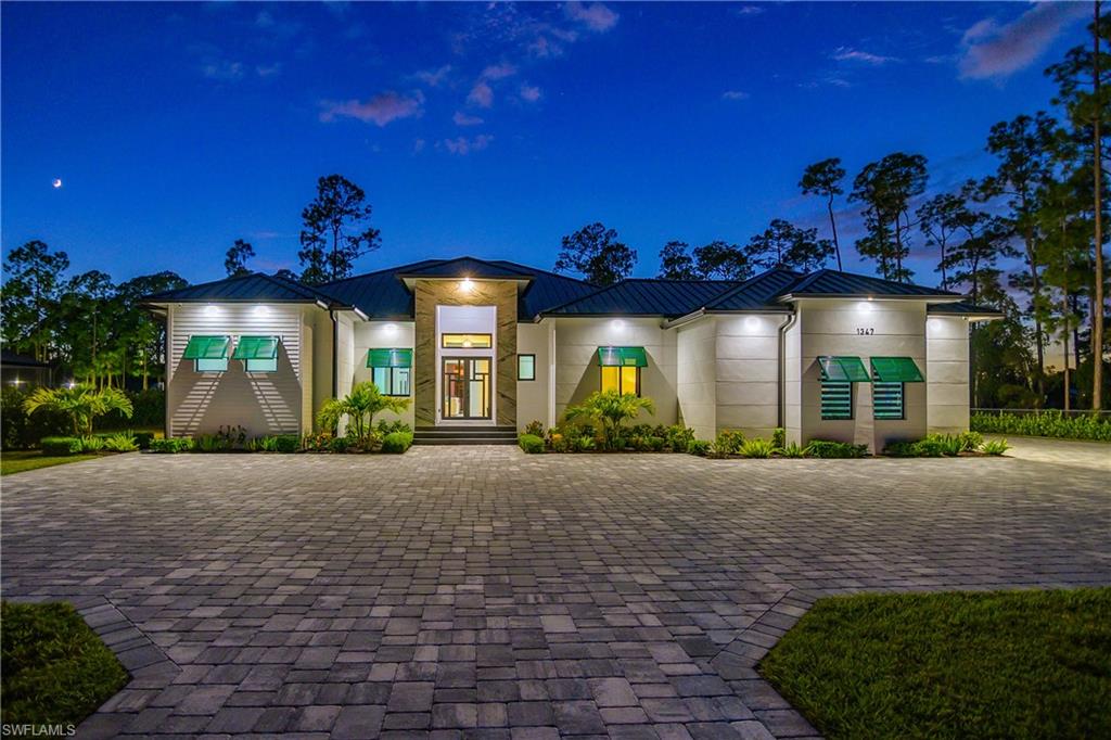 1347 23rd Street Southwest Naples, FL 34117 - Photo 48 of 50 a view of a building with a yard in front of it