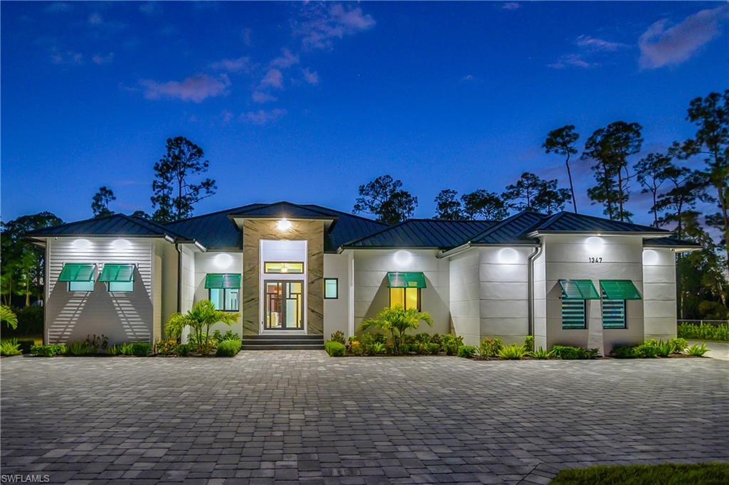 1347 23rd Street Southwest Naples, FL 34117 - Photo 49 of 50 front view of a house with a yard