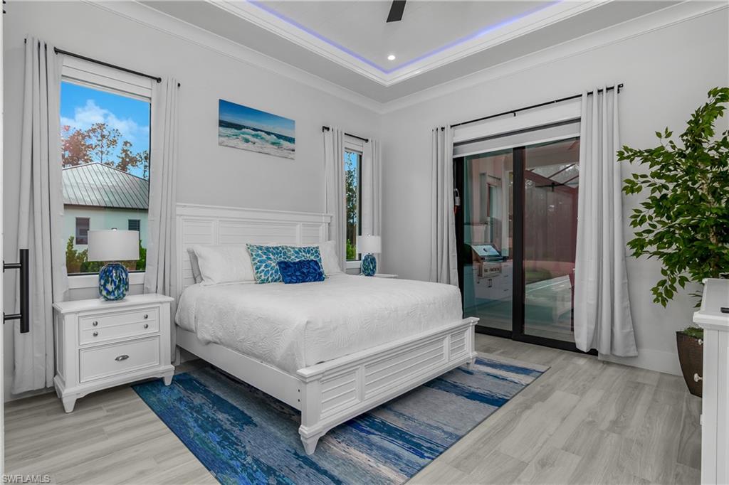 1347 23rd Street Southwest Naples, FL 34117 - Photo 6 of 50 a bedroom with a large bed and a potted plant