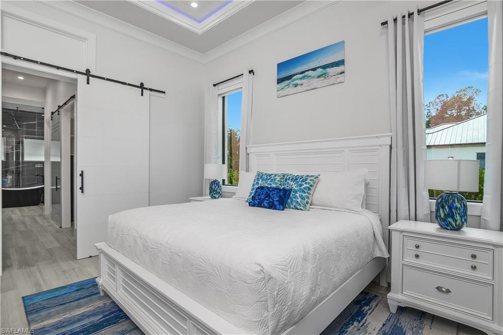 1347 23rd Street Southwest Naples, FL 34117 - Photo 8 of 50 a bedroom with a bed and a dresser