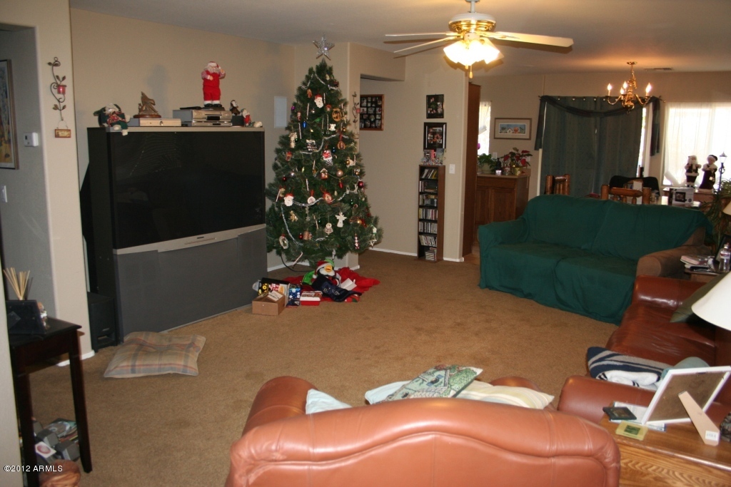 17436 West Boca Raton Road Surprise, AZ 85388 - Photo 2 of 10 a living room with furniture and flowers