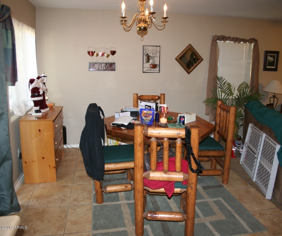 17436 West Boca Raton Road Surprise, AZ 85388 - Photo 4 of 10 a view of a dining room with furniture and a chandelier