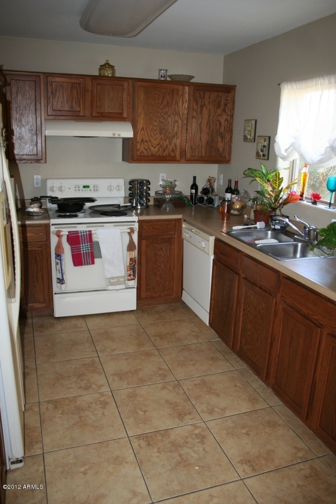 17436 West Boca Raton Road Surprise, AZ 85388 - Photo 5 of 10 a kitchen with a sink and cabinets