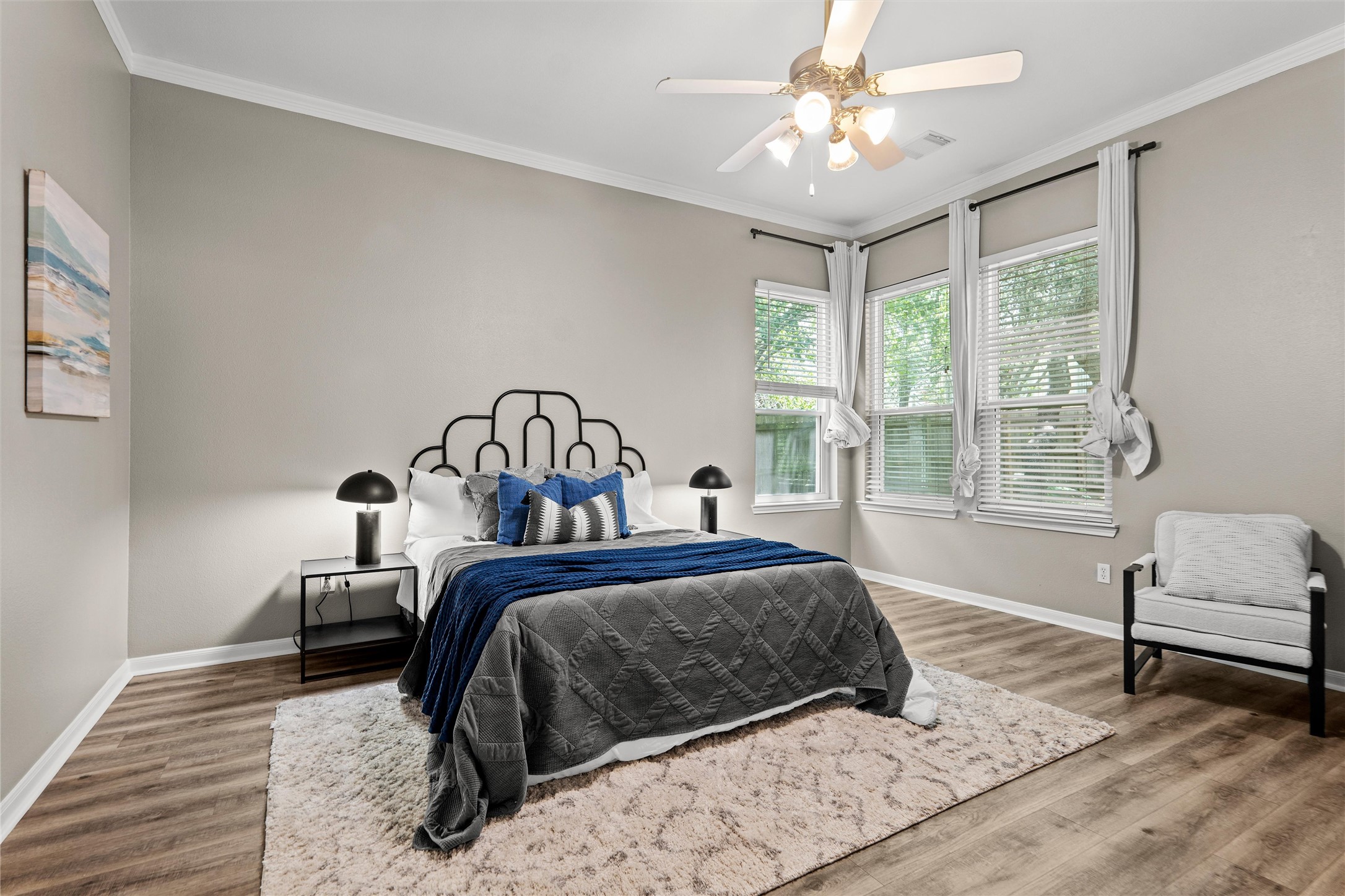 7000 Colberg Court Austin, TX 78749 - Photo 18 of 40 Hardwood floors and multiple windows illuminate this inviting bedroom, perfect for peaceful repose.