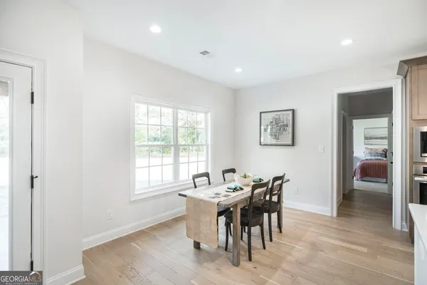 a view of a dining room with furniture and window