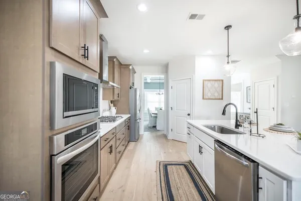 a kitchen with a sink stove and microwave