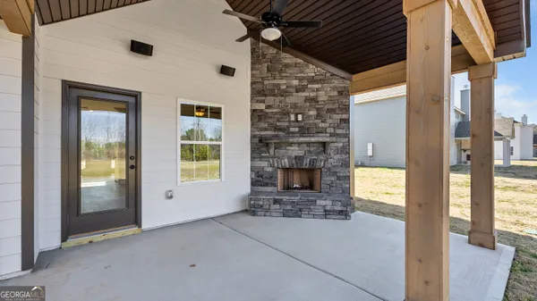 a view of a livingroom with a fireplace and a window