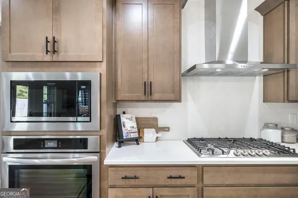 a kitchen with granite countertop a stove and a sink