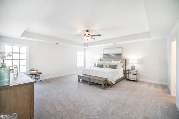 a spacious bedroom with a bed and a couch