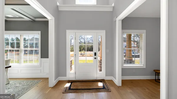 a view of an entryway with wooden floor