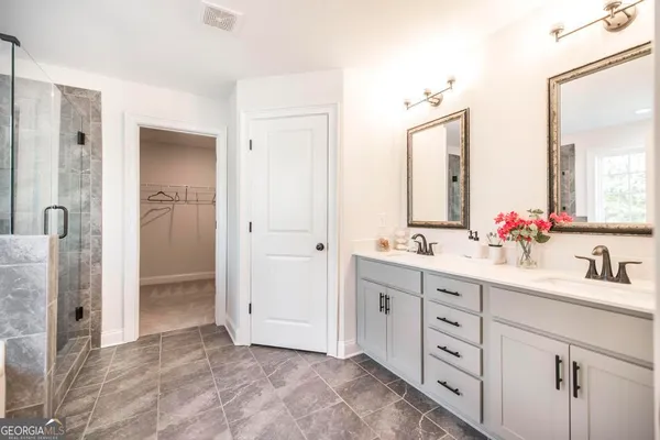 a bathroom with a double vanity sink mirror and double