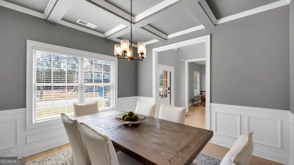 a view of a dining room with furniture window and wooden floor