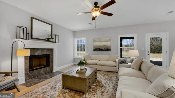 a living room with furniture a window and a fireplace