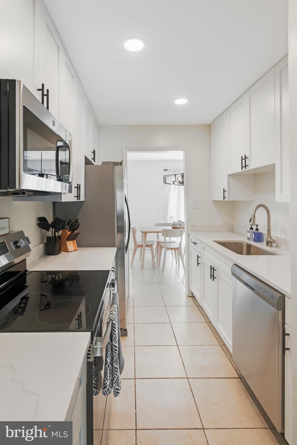 428 Reneau Way Herndon, VA 20170 - Photo 13 of 45 a kitchen with a stove a sink and a refrigerator