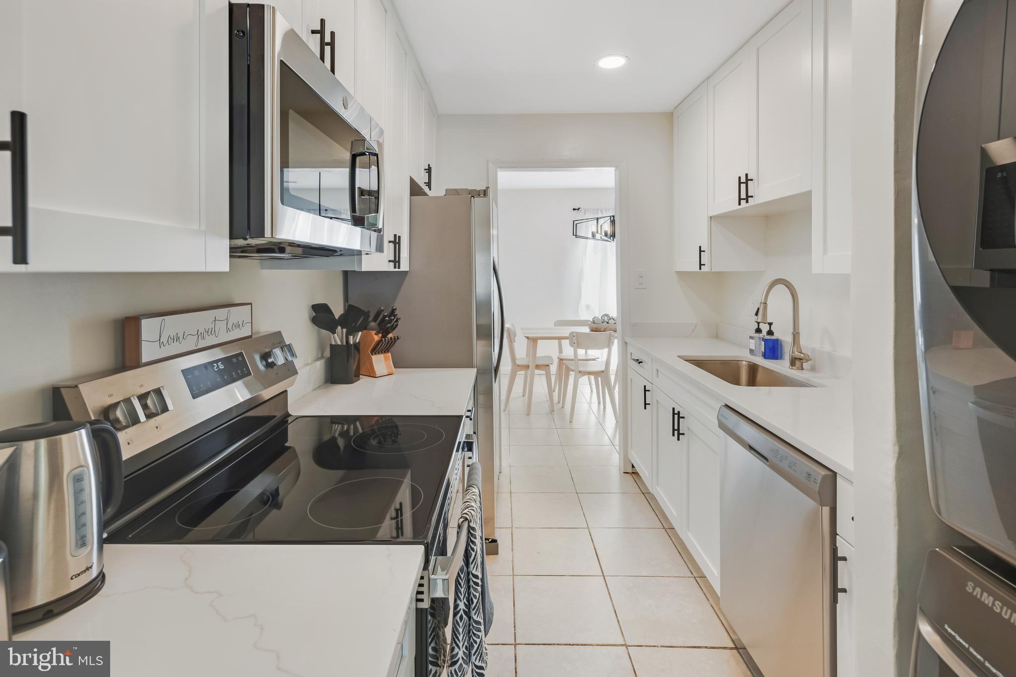 428 Reneau Way Herndon, VA 20170 - Photo 17 of 45 a kitchen with stainless steel appliances granite countertop a sink stove and cabinets