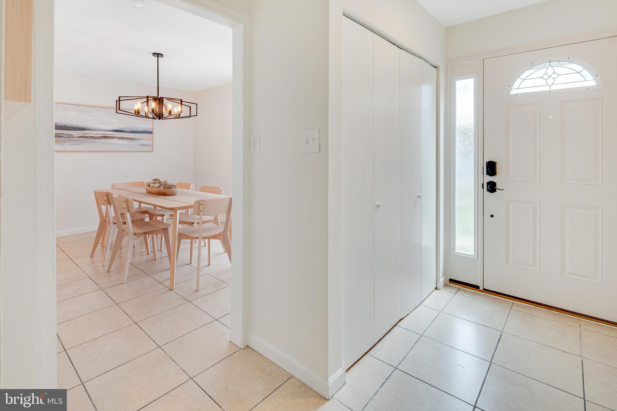 428 Reneau Way Herndon, VA 20170 - Photo 23 of 45 a dining room with chandelier and entryway