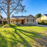 a front view of a house with a yard table and chairs