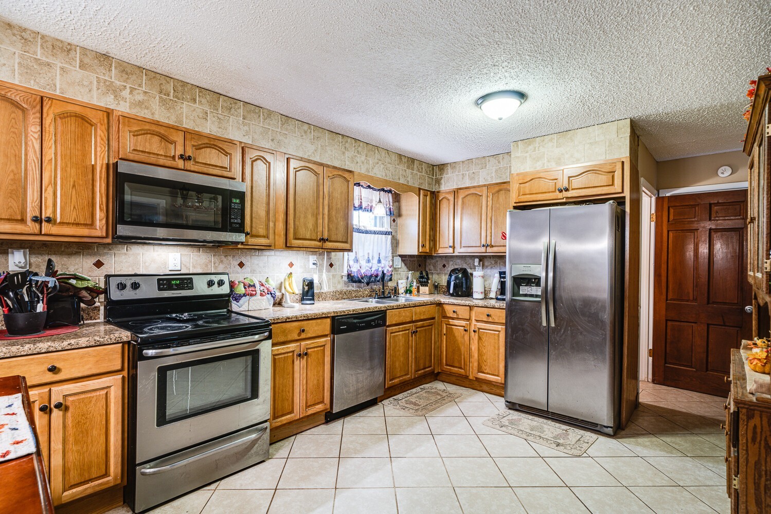 2757 Dale Ridge Road Dowelltown, TN 37059 - Photo 15 of 28 a kitchen with stainless steel appliances granite countertop a stove top oven a refrigerator and a sink