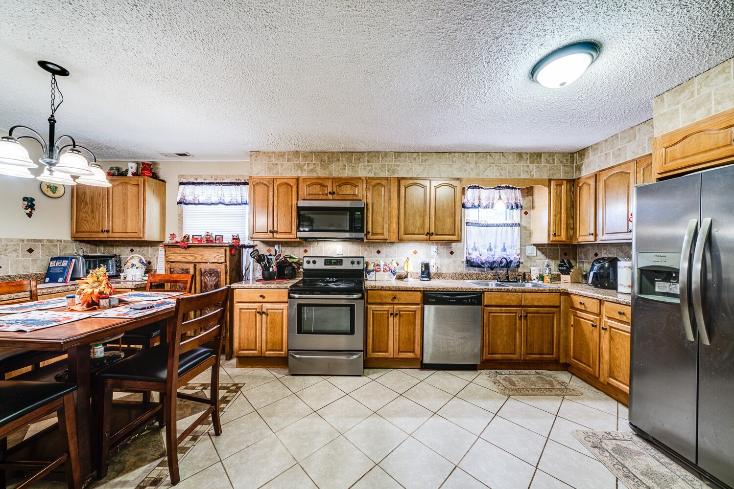 2757 Dale Ridge Road Dowelltown, TN 37059 - Photo 16 of 28 a kitchen with stainless steel appliances granite countertop a stove top oven a sink dishwasher and a refrigerator