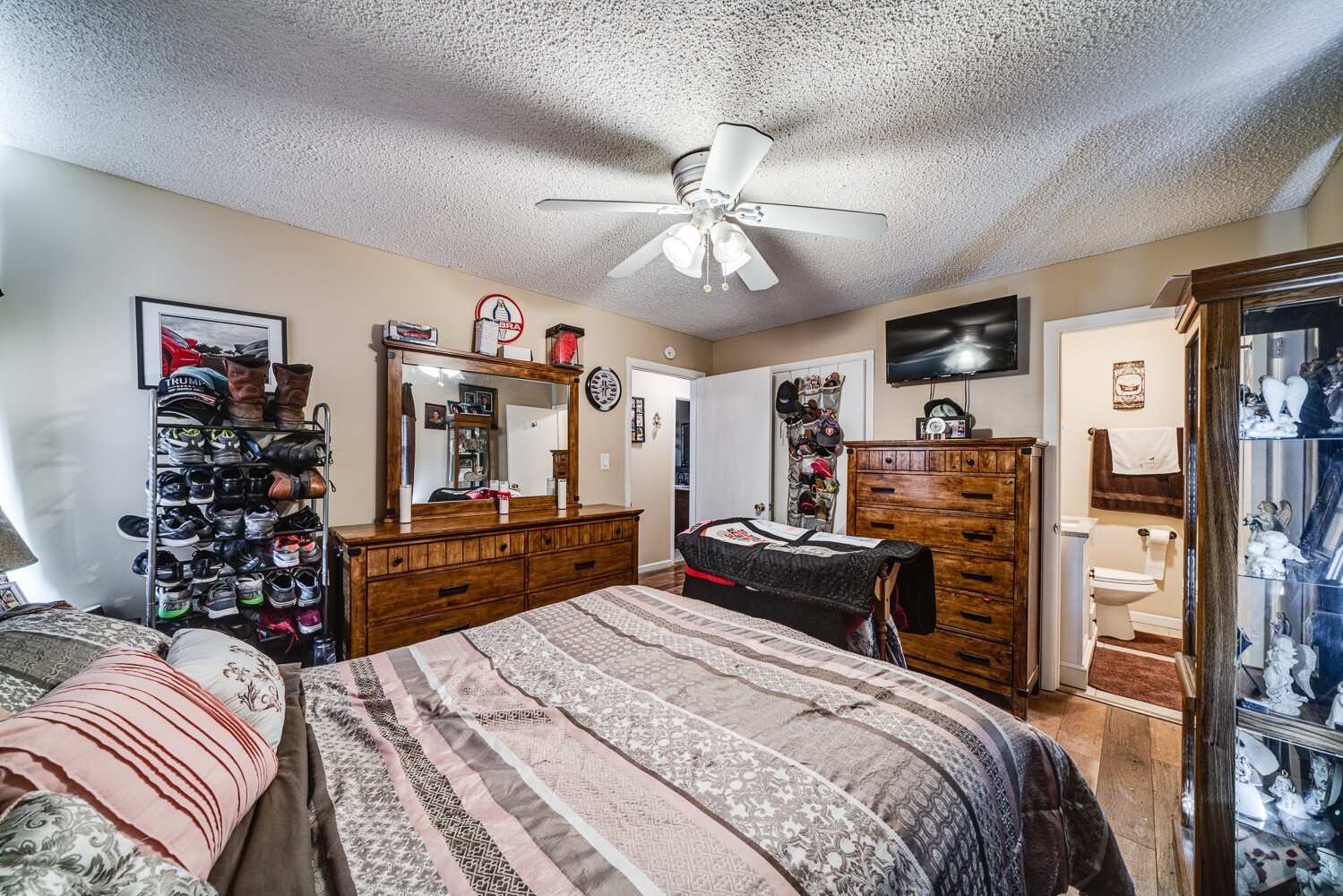 2757 Dale Ridge Road Dowelltown, TN 37059 - Photo 20 of 28 a bedroom with a bed dresser and a chandelier