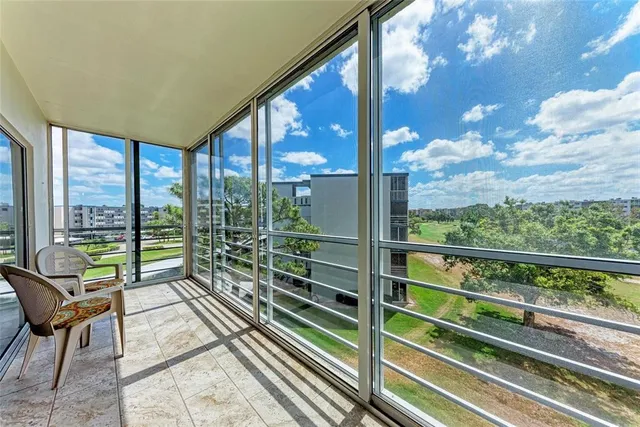 a view of a room with wooden floor and outdoor seating