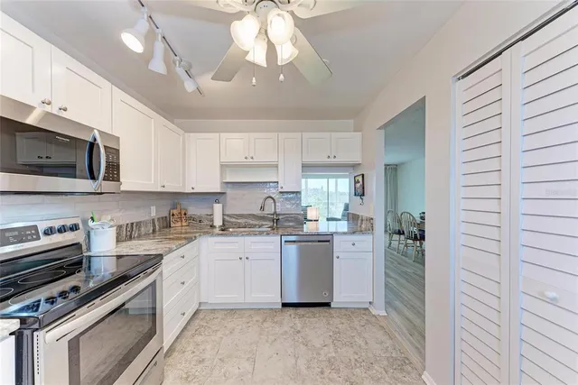 a kitchen with a stove a sink and cabinets