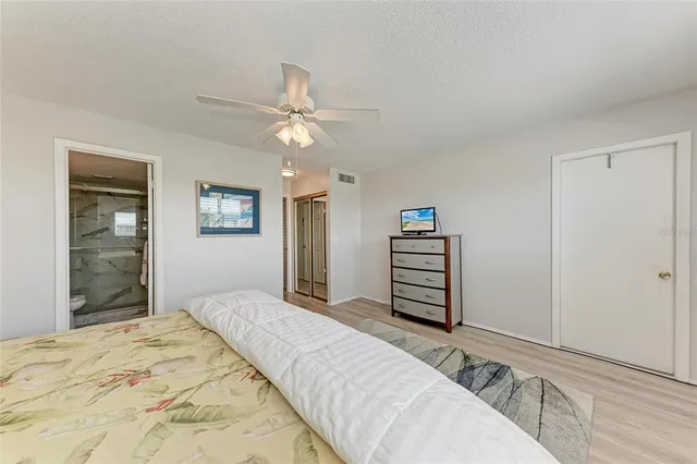 a bedroom with a bed dresser and a window