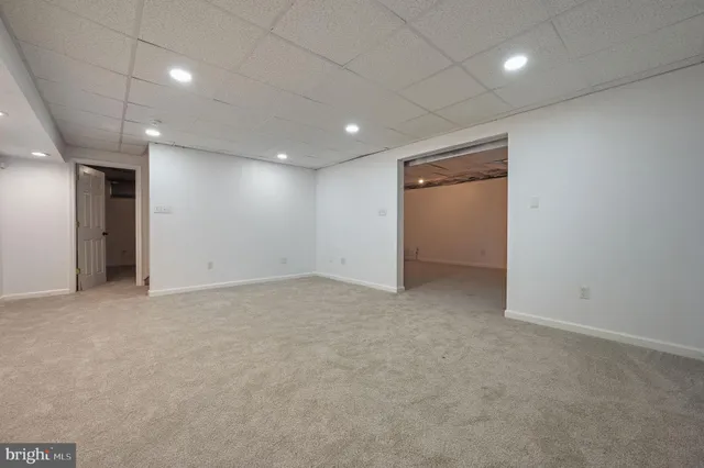 an empty room with a empty space and windows