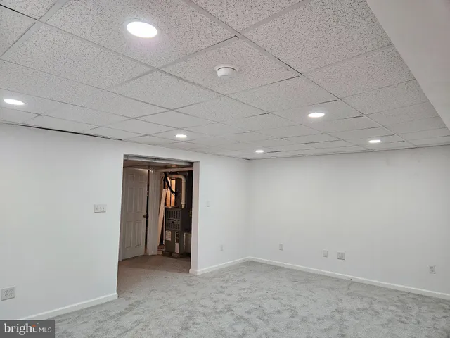 an empty room with closet and a window