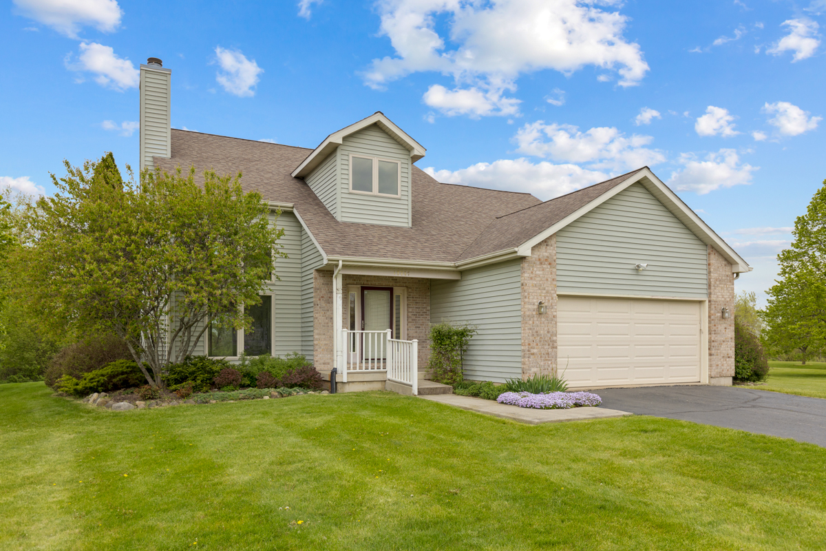 17717 Springbrook Circle Union, IL 60180 - Photo 1 of 33 a front view of a house with a garden and yard