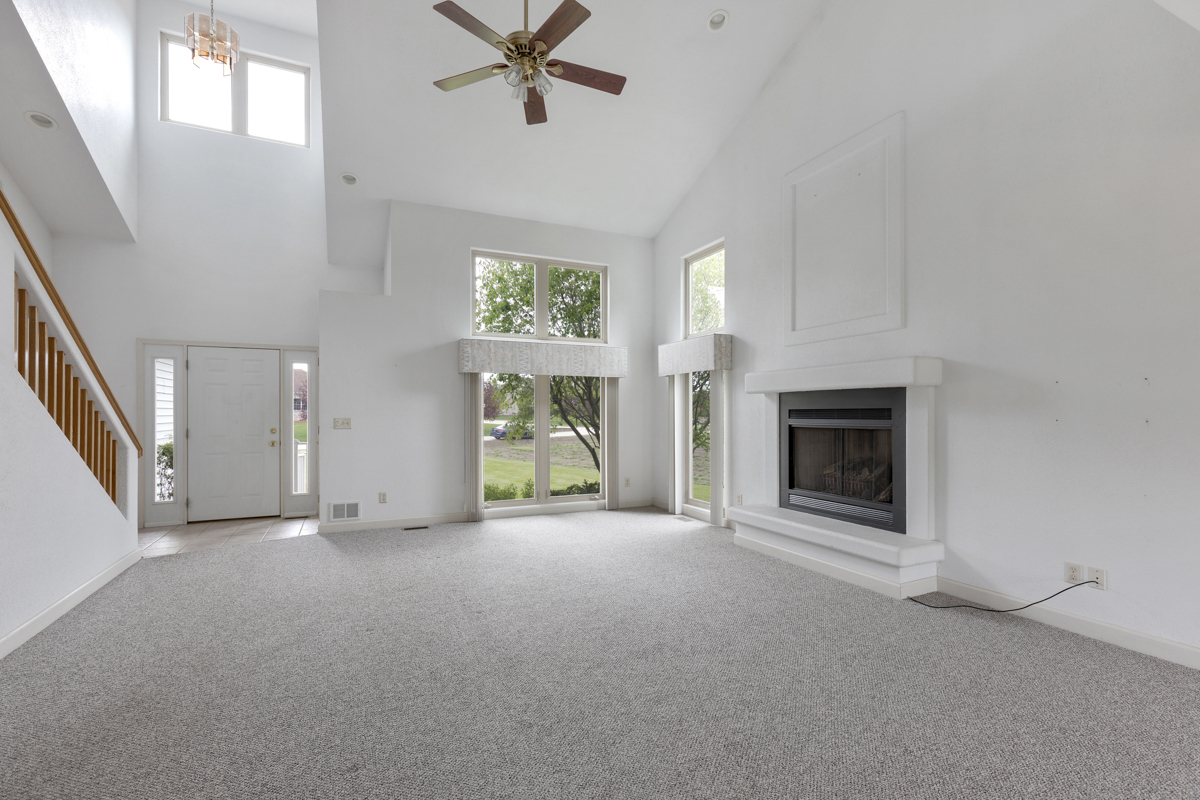 17717 Springbrook Circle Union, IL 60180 - Photo 2 of 33 an empty room with windows and fireplace