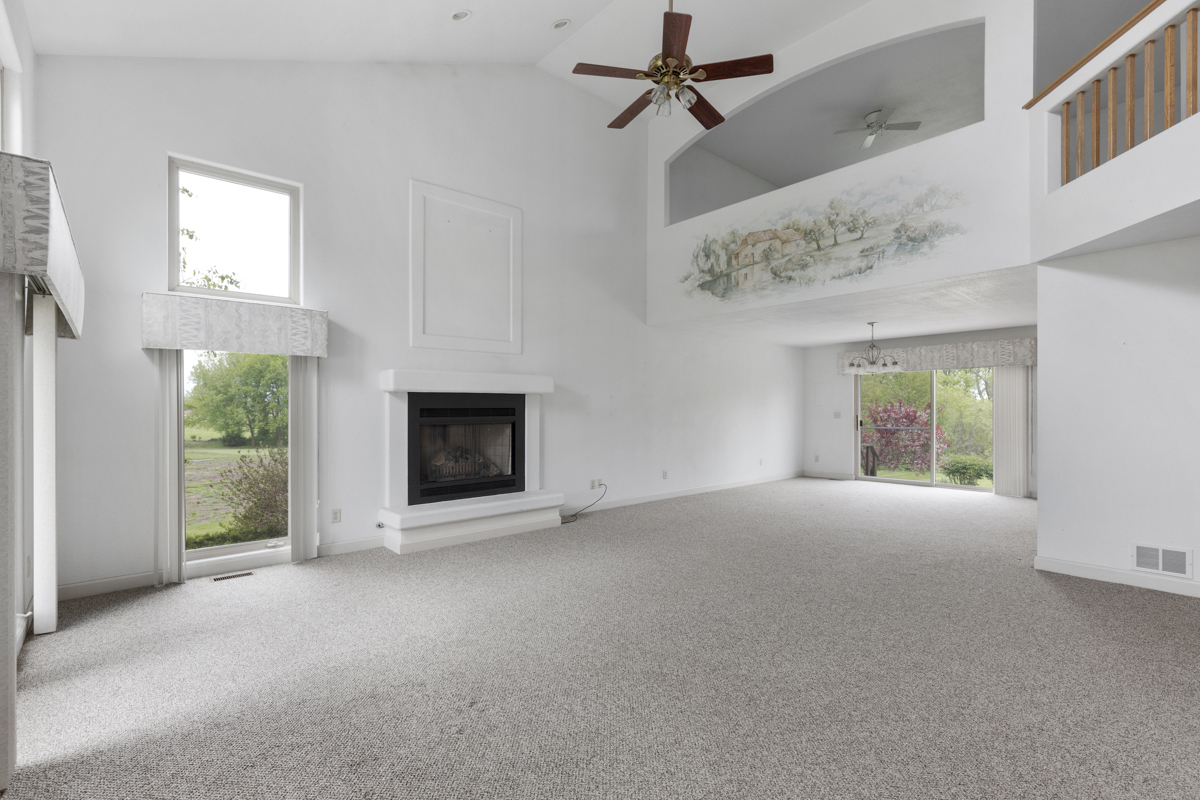 17717 Springbrook Circle Union, IL 60180 - Photo 3 of 33 en empty room with windows and fireplace