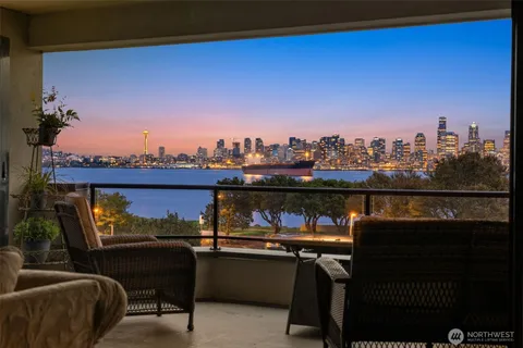 a view of a chairs and table in a balcony