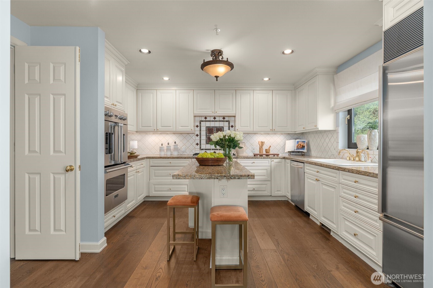 1333 Harbor Avenue Southwest, Unit 204 Seattle, WA 98116 - Photo 11 of 27 a kitchen with white cabinets and stainless steel appliances