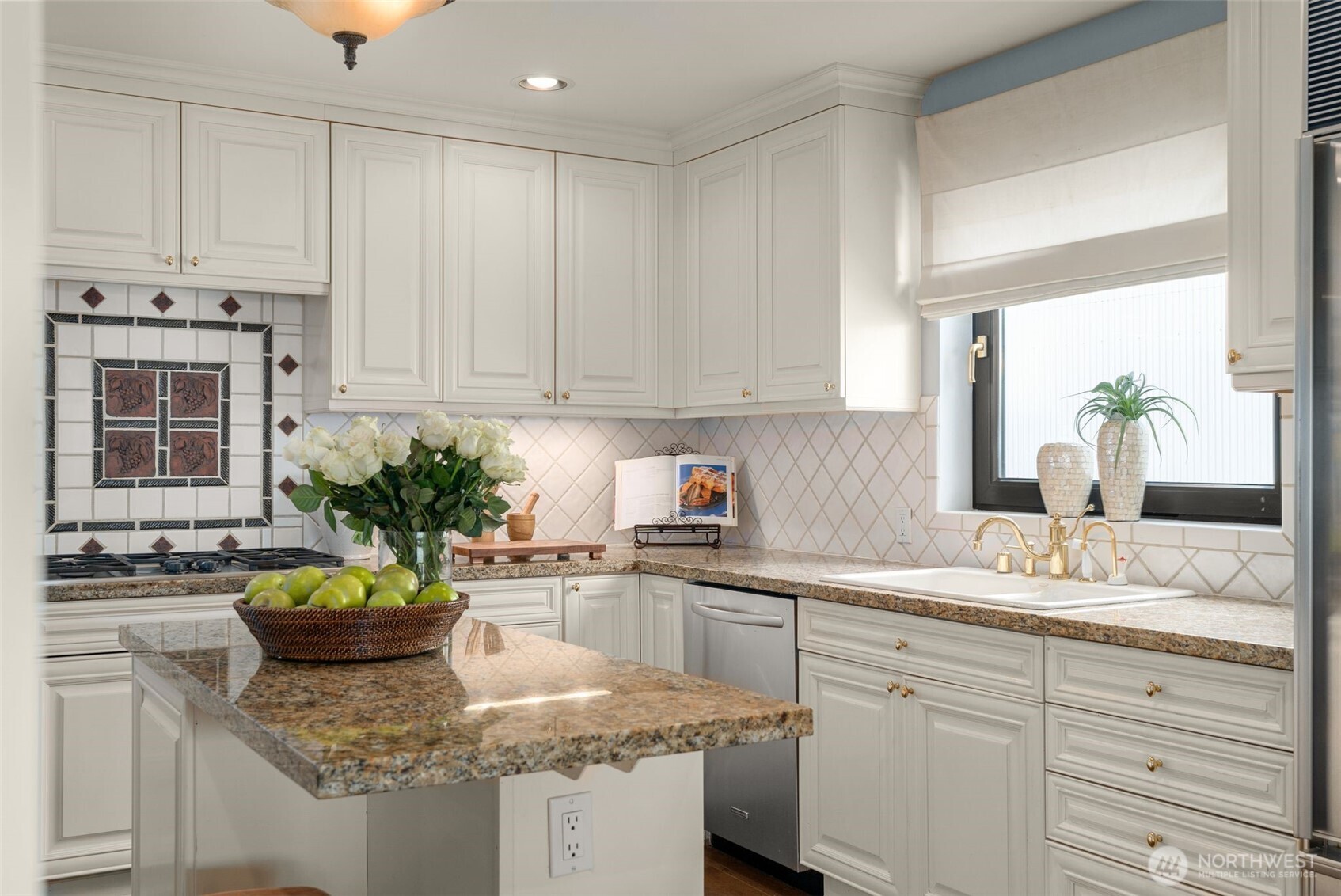 1333 Harbor Avenue Southwest, Unit 204 Seattle, WA 98116 - Photo 12 of 27 a kitchen with kitchen island granite countertop a sink a window and cabinets
