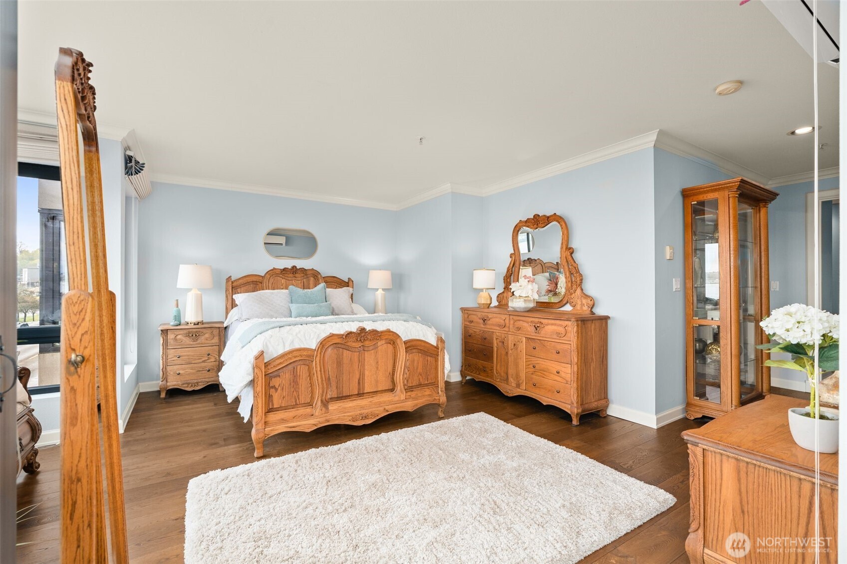 1333 Harbor Avenue Southwest, Unit 204 Seattle, WA 98116 - Photo 17 of 27 a bedroom with a bed and wooden floor