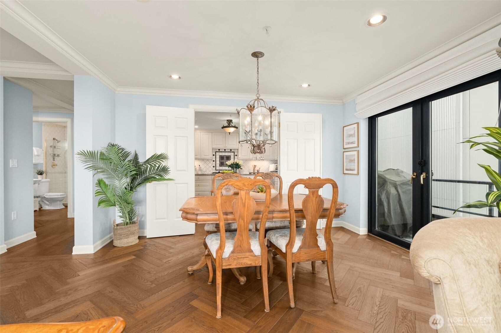 1333 Harbor Avenue Southwest, Unit 204 Seattle, WA 98116 - Photo 10 of 27 a dining room with furniture potted plants and wooden floor
