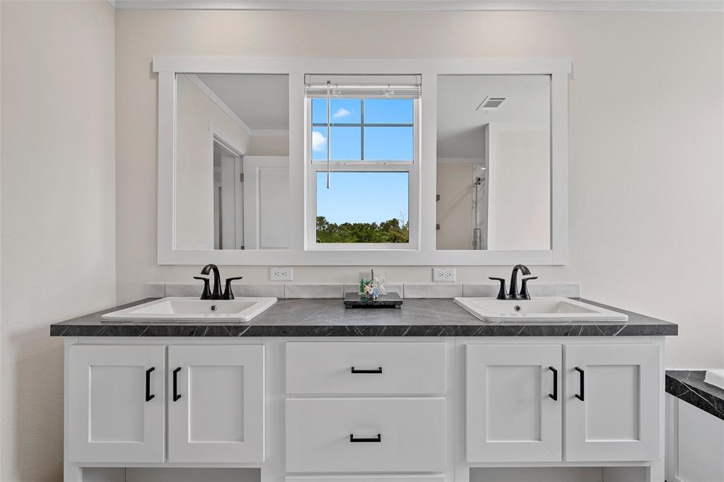 3050 Clater Powell Road Waco, TX 76705 - Photo 22 of 39 a bathroom with double sink and a mirror
