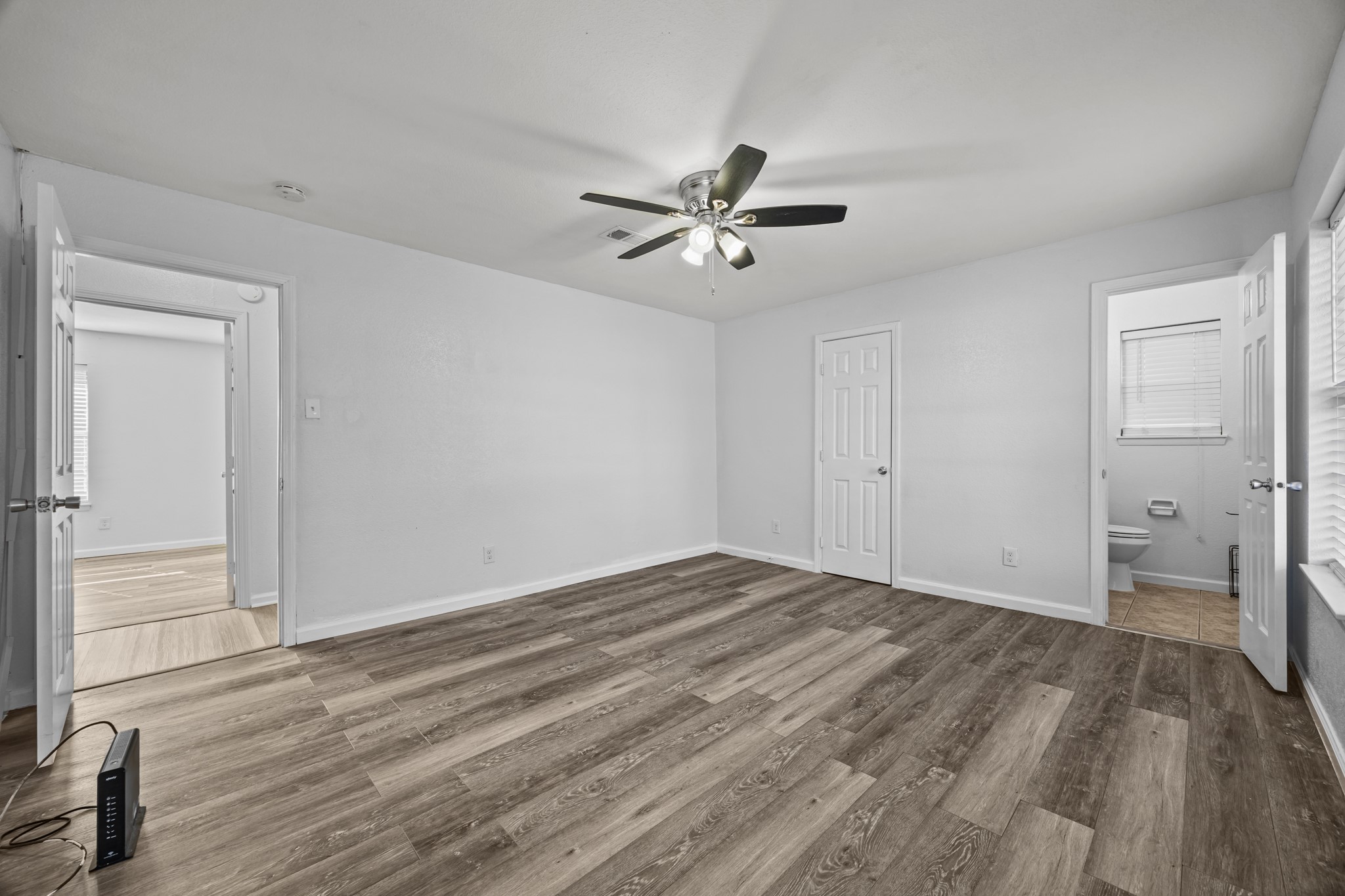 2103 6th Street Stafford, TX 77477 - Photo 14 of 27 a view of empty room with wooden floor and fan