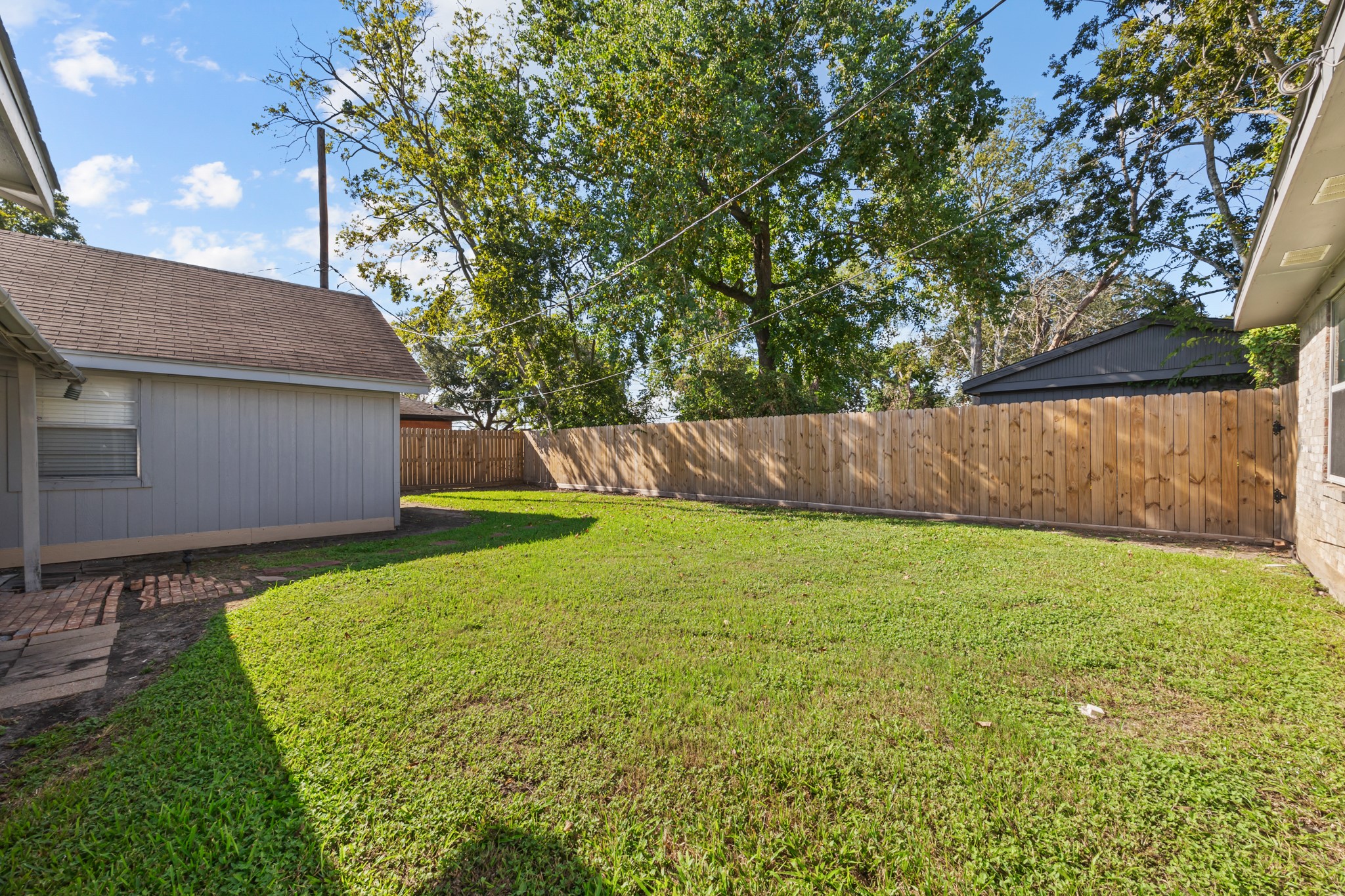 2103 6th Street Stafford, TX 77477 - Photo 25 of 27 a view of a backyard with a garden