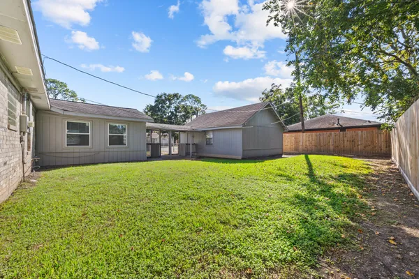 a view of a house with a backyard