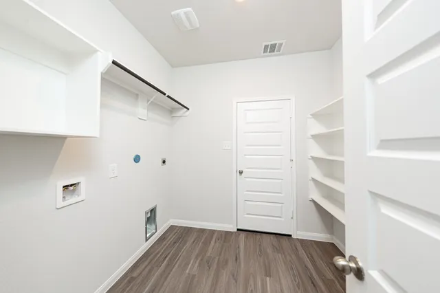 a view of walk in closet with empty racks