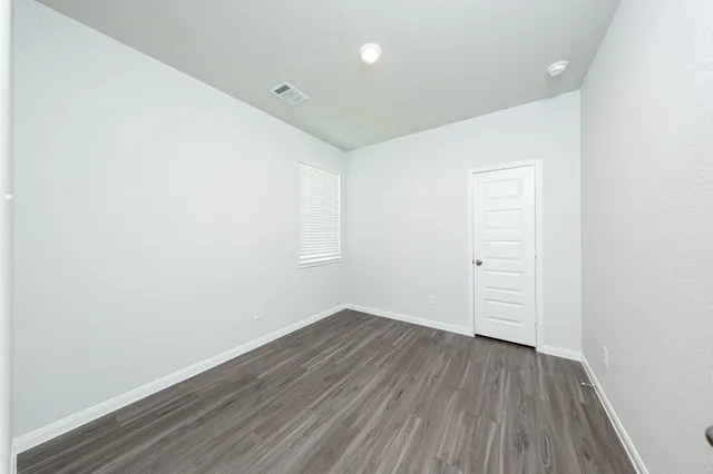 an empty room with wooden floor